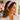 Woman in a white blouse by a window wearing the Brown/Green Zinnia Headband by Hadley Pollet, lavender with pink flowers