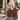 Woman in a linen shirt and jeans on a sunny street carrying the Burgundy Flutter Tote by Hadley Pollet with teal butterflies