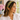 Woman in a white blouse by a window wearing the Burgundy Zinnia Dot Headband by Hadley Pollet with burgundy zinnias on green