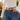 Red and cream reverse side of the Cactus Zinnia Belt by Hadley Pollet, worn with jeans and a white bell-sleeve top