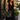 Woman in a black dress with coffee carrying the Chestnut Lovebug Tote by Hadley Pollet with cream flower and beetle print
