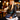 Woman in a leather jacket at a restaurant bar holding the Midnight Peek-a-Boo Clutch by Hadley Pollet