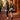 Two women posing on a city sidewalk with the Midnight and Walnut Peek-a-Boo Clutches by Hadley Pollet