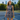 Woman on a city tennis court in the Navy Red Waves Zinnia Sleeveless Tennis Dress by Hadley Pollet with a striped zip collar