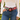 Pinkest Zinnia Belt by Hadley Pollet with pink and green zinnias and a round tortoise buckle, worn with jeans in a garden