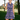 Smiling woman with a golf club on a course in the Purple Waves Zinnia Sleeveless Tennis Dress by Hadley Pollet