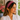 Smiling woman in a white blouse wearing the Red Zinnia Dot Headband by Hadley Pollet, red with light blue dots