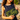 Smiling woman on a beach holding the Seaside Peek-a-boo Clutch by Hadley Pollet, black cutout leather over lime green